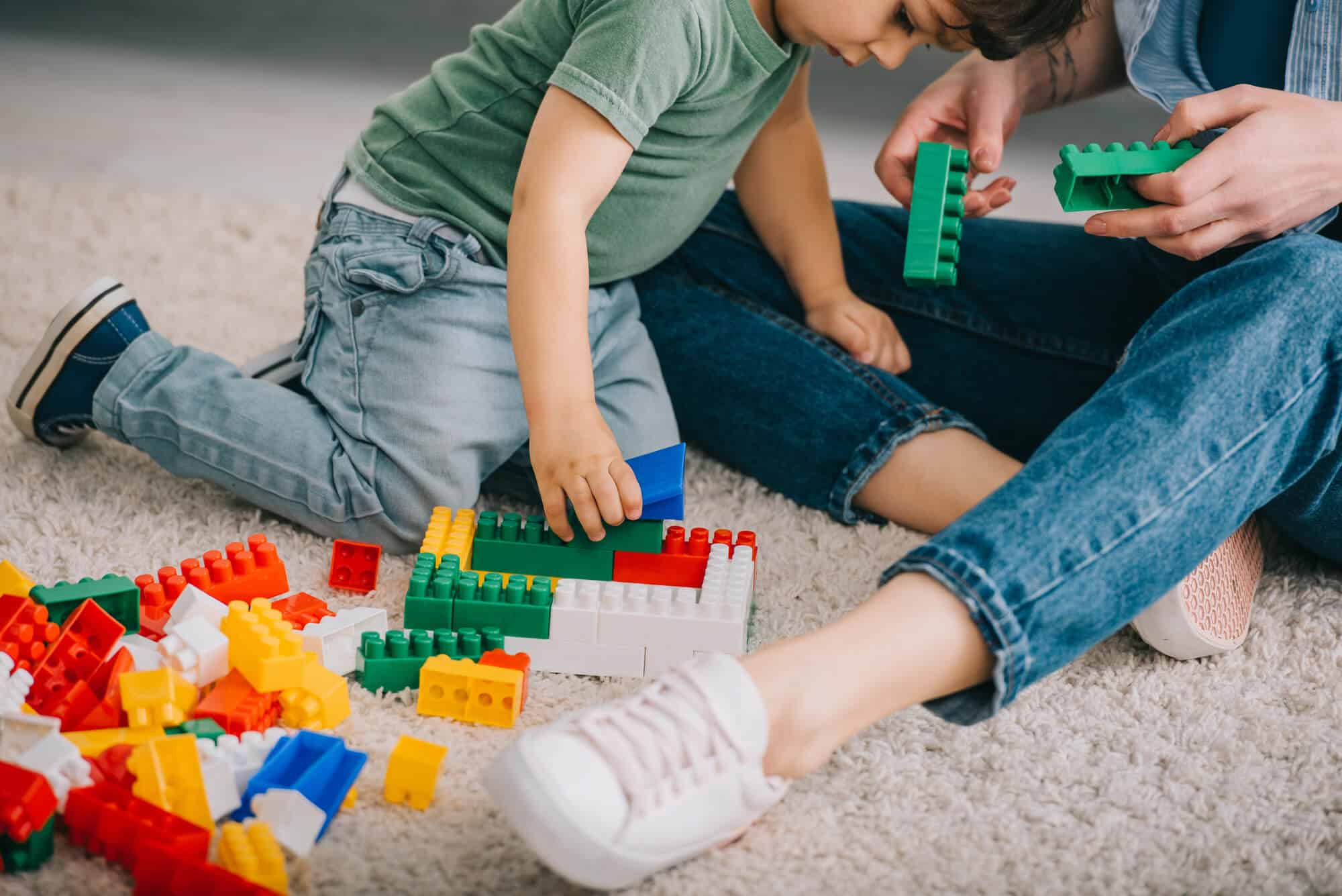 boy playing with legos